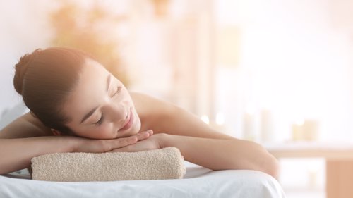 Beautiful young woman in spa salon